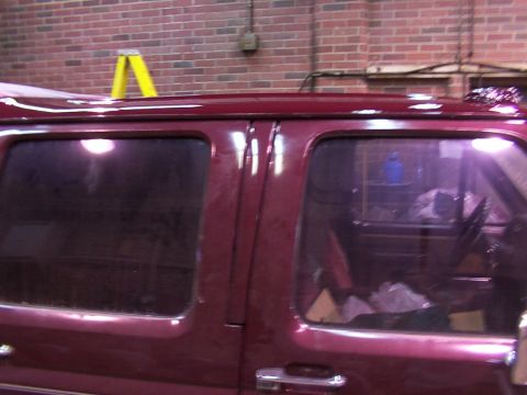 1988 Ford C-350 (Centurion Conversions) - Maroon van side profile with a yellow ladder on the roof.
