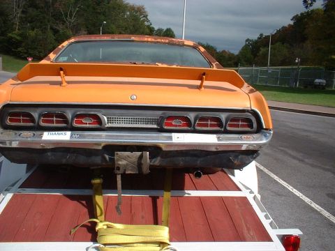 1970 Mercury Cyclone - Rear view of an orange 1970 Mercury Cyclone on a trailer, a prominent spoiler and quad taillights.
