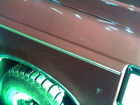 1988 Ford C-350 (Centurion Conversions) - A close view of a vehicle's fender and tire, showing the paint detail and tread pattern.