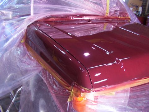 1988 Ford C-350 (Centurion Conversions) - A vehicle hood is covered in plastic and tape, indicating it is in the process of being painted.