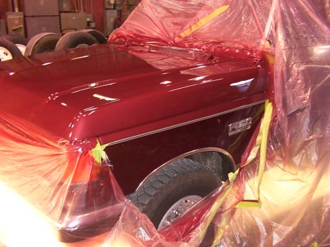 1988 Ford C-350 (Centurion Conversions) - 1988 Ford C-350 (Centurion Conversions) fender and hood are covered in plastic sheeting during a paint job.