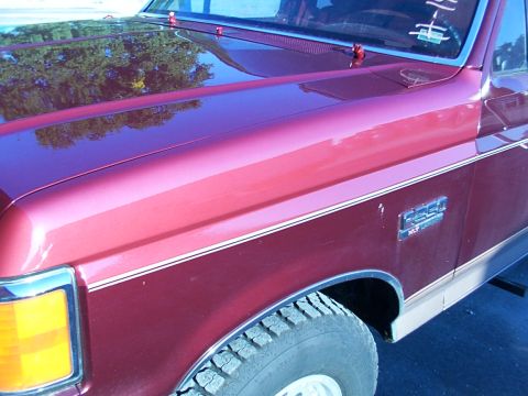 1988 Ford C-350 (Centurion Conversions) - Maroon Ford F-Series truck with chrome trim and a two-tone paint job. The hood and fender are visible.