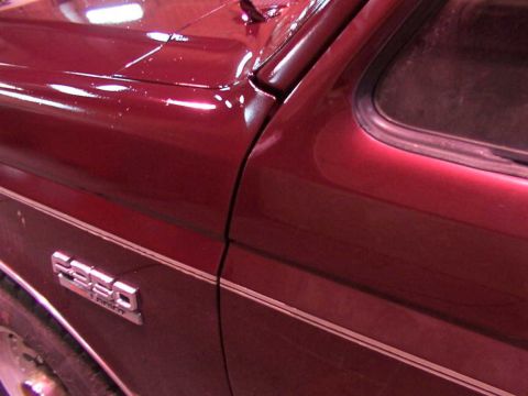 1988 Ford C-350 (Centurion Conversions) - Close-up of a red Ford F-350 emblem on the side of the vehicle.
