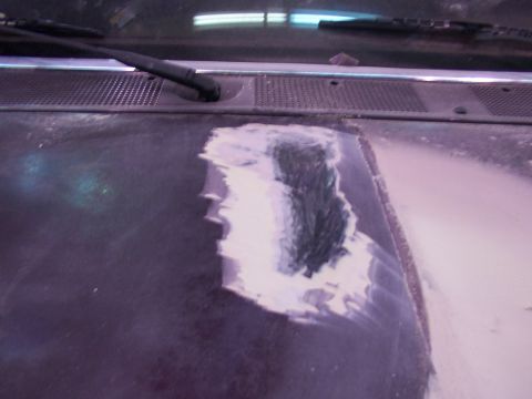 1988 Ford C-350 (Centurion Conversions) - The hood of a vehicle shows a section undergoing bodywork repair with filler material.