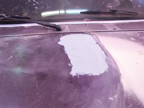 1988 Ford C-350 (Centurion Conversions) - Body filler is applied to a section of the vehicle's hood, indicating repair work.