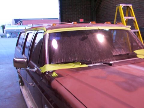 1988 Ford C-350 (Centurion Conversions) - Ford F-Series truck's windshield is taped off, indicating preparation for bodywork or painting.