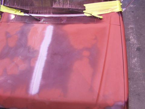 1988 Ford C-350 (Centurion Conversions) - Hood of a vehicle undergoing bodywork, showing primer and masking tape.