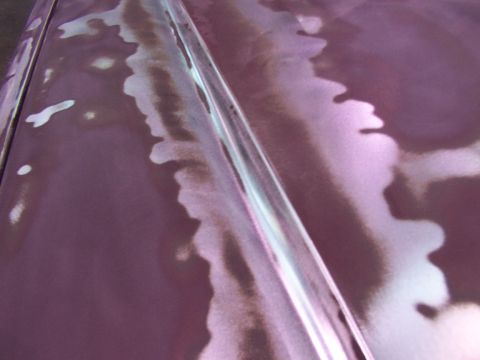 1988 Ford C-350 (Centurion Conversions) - The hood of a vehicle shows areas of primer and exposed metal beneath the paint.