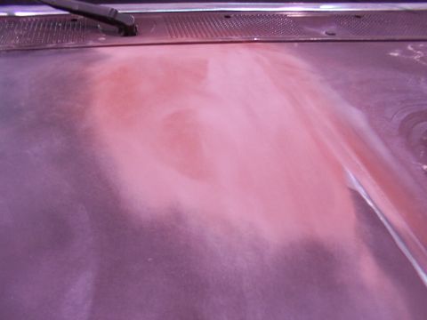 1988 Ford C-350 (Centurion Conversions) - Close-up of a vehicle hood showing sanding dust and a windshield wiper, indicating bodywork in progress.