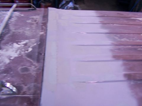 1988 Ford C-350 (Centurion Conversions) - The roof panel of a vehicle is shown with primer and sanding dust, indicating bodywork in progress.