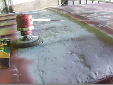 1988 Ford C-350 (Centurion Conversions) - A power sander is used to prepare the roof of a vehicle for a new paint job.