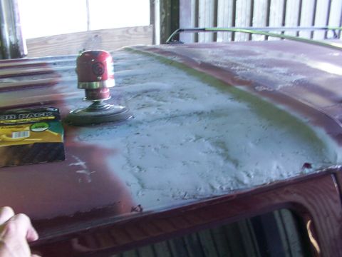 1988 Ford C-350 (Centurion Conversions) - A power sander and sandpaper are used to prepare the roof of a vehicle for repair.