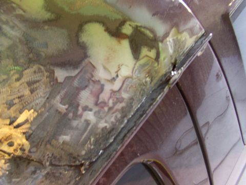 1988 Ford C-350 (Centurion Conversions) - The vehicle's metal panel shows significant rust and damage, with multiple layers of paint visible.