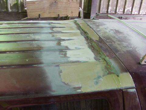 1988 Ford C-350 (Centurion Conversions) - Body filler being applied to a vehicle's roof seams during repair work.