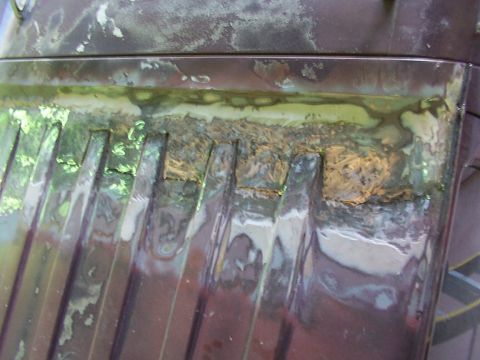 1988 Ford C-350 (Centurion Conversions) - This image shows a close-up of damaged and repaired vehicle bodywork, likely a section of the roof, with visible rust and filler.