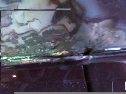 1988 Ford C-350 (Centurion Conversions) - The underside of a vehicle displays significant rust and damage, indicating potential structural issues.