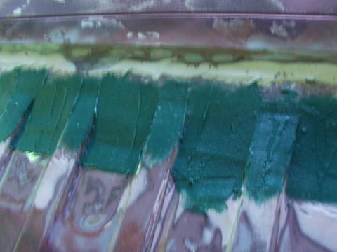 1988 Ford C-350 (Centurion Conversions) - Body filler is applied to a textured metal surface, likely for repair or modification.