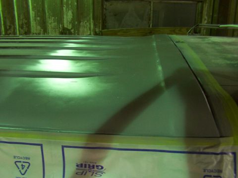 1988 Ford C-350 (Centurion Conversions) - The image shows a close-up of a vehicle's roof panel, with protective sheeting below.