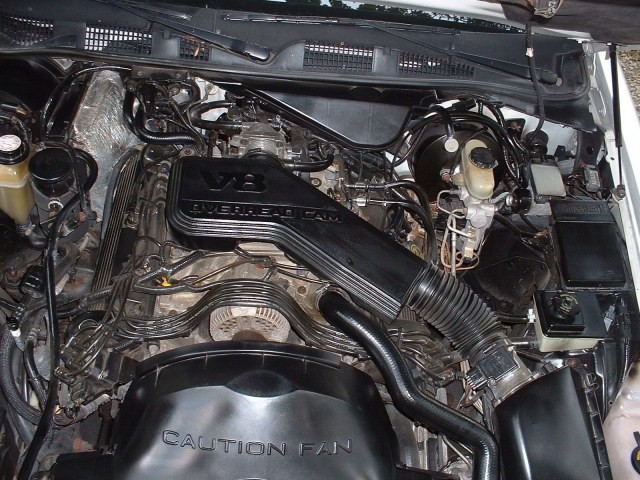 Engine bay showing a V8 Overhead Cam engine with Caution Fan shroud