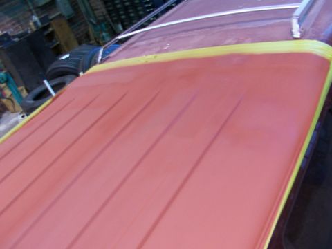 1988 Ford C-350 (Centurion Conversions) - The ribbed roof panel is covered in red primer and masked with yellow tape, suggesting preparation for bodywork.