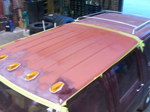 1988 Ford C-350 (Centurion Conversions) - The roof of a vehicle is prepped for painting, with amber clearance lights installed.