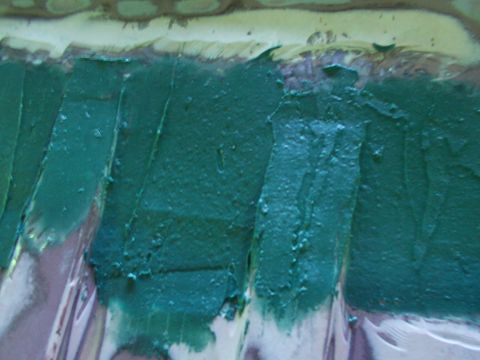 1988 Ford C-350 (Centurion Conversions) - Close-up view of green body filler being applied to a metal surface, likely for automotive repair.
