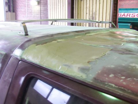 1988 Ford C-350 (Centurion Conversions) - Vehicle roof undergoing bodywork repair with filler applied. Roof rack rails are present.