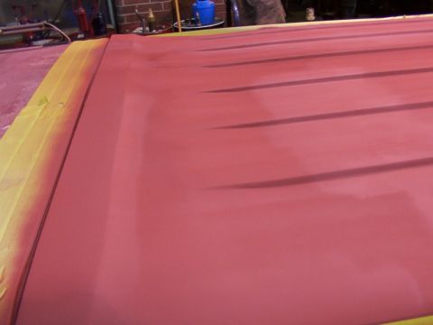 1988 Ford C-350 (Centurion Conversions) - A red roof panel, partially covered with yellow tape, is visible in this close-up shot.