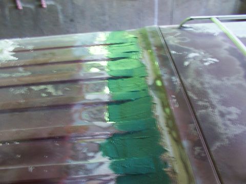1988 Ford C-350 (Centurion Conversions) - Body filler is applied to the ribbed roof of a vehicle during a repair process.