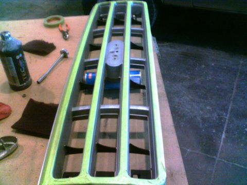 1988 Ford C-350 (Centurion Conversions) - A Ford truck grille is prepped for painting, with masking tape applied around the edges.