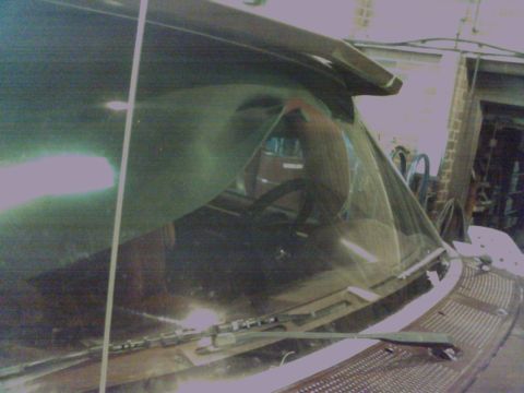 1988 Ford C-350 (Centurion Conversions) - The interior of a truck is visible, focusing on the windshield and dashboard area, with a visor overhead.