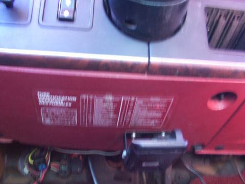 1988 Ford C-350 (Centurion Conversions) - A sticker with vehicle information is affixed to the dashboard of a vehicle, with wiring visible underneath.