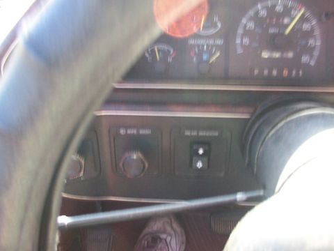 1988 Ford C-350 (Centurion Conversions) - Interior view of a 1988 Ford C-350 (Centurion Conversions) dashboard, showing gauges and control buttons.