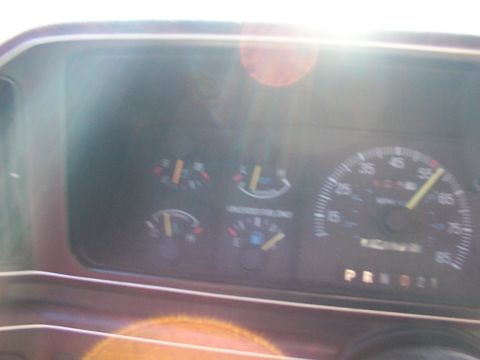 1988 Ford C-350 (Centurion Conversions) - The dashboard of a vehicle shows various gauges, including a speedometer, fuel gauge, and oil pressure gauge, with the gear selector illumi…
