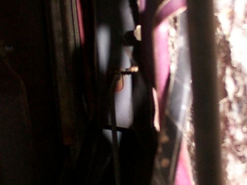 1988 Ford C-350 (Centurion Conversions) - Close-up view of a door lock mechanism, partially obscured by purple trim and fabric.