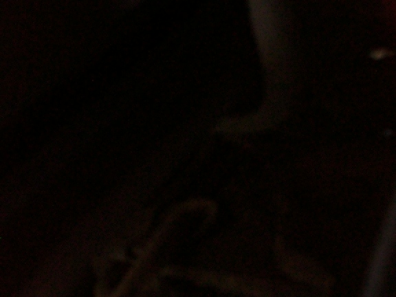 Close-up of a dark, possibly metal, car door lock motor part