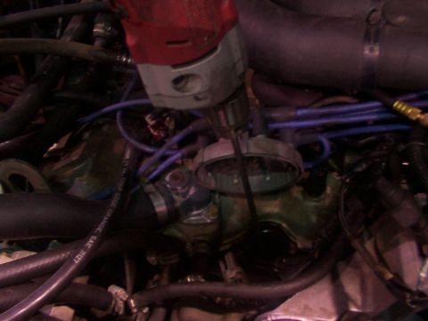 1988 Ford C-350 (Centurion Conversions) - A drill is used on an engine component, obscuring specific vehicle identification.
