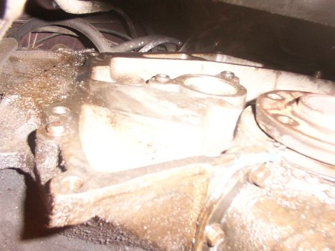 1988 Ford C-350 (Centurion Conversions) - Close-up view of a greasy transmission housing, likely showing signs of fluid leakage.