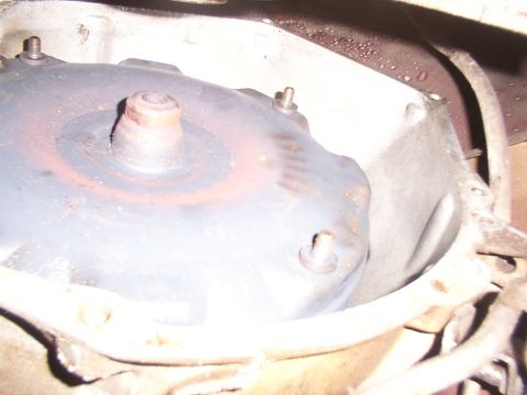 1988 Ford C-350 (Centurion Conversions) - Close-up view of a vehicle's torque converter, showing its metallic components and signs of wear.