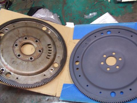 1988 Ford C-350 (Centurion Conversions) - A used flywheel with markings and a newly painted flywheel are shown side-by-side.