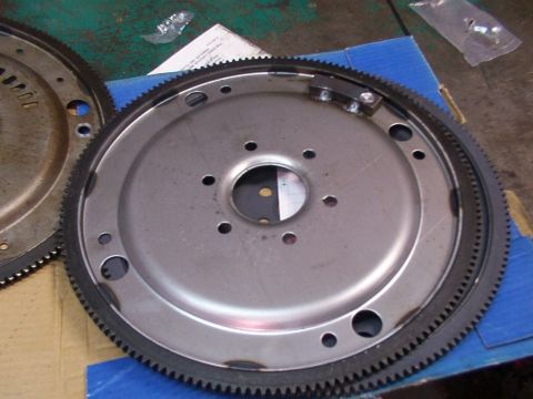 1988 Ford C-350 (Centurion Conversions) - A metal flywheel with a ring gear and bolt holes is shown.