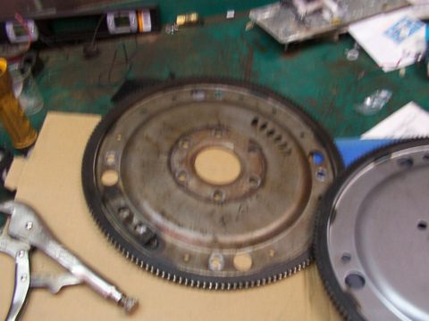 1988 Ford C-350 (Centurion Conversions) - A flywheel, likely for a Ford C-350, is shown with a pair of vise grips.