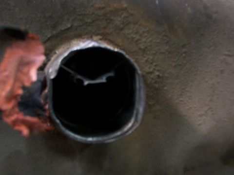 1988 Ford C-350 (Centurion Conversions) - This is a close-up view of a hole in the undercarriage of a vehicle, likely related to the fuel system.