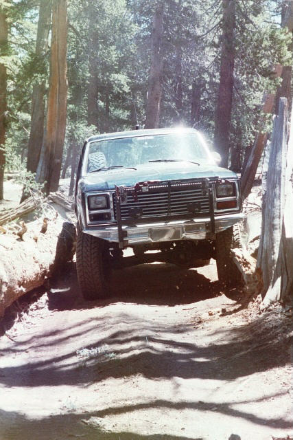 1994 Ford Bronco - This 1994 Ford Bronco navigates a challenging off-road trail, its capabilities and aftermarket modifications.