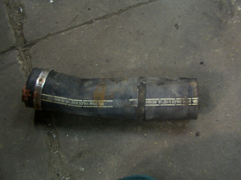 1988 Ford C-350 (Centurion Conversions) - A rubber hose with two metal clamps is shown on a concrete surface.
