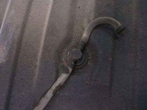 1988 Ford C-350 (Centurion Conversions) - A close-up view of a fuel tank sender unit with a bent fuel line attached.
