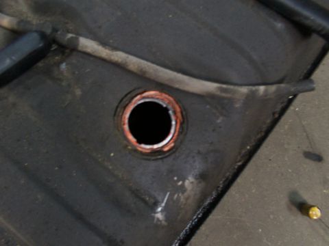 1988 Ford C-350 (Centurion Conversions) - Close-up view of an opening on a vehicle's fuel tank, showing a copper seal.