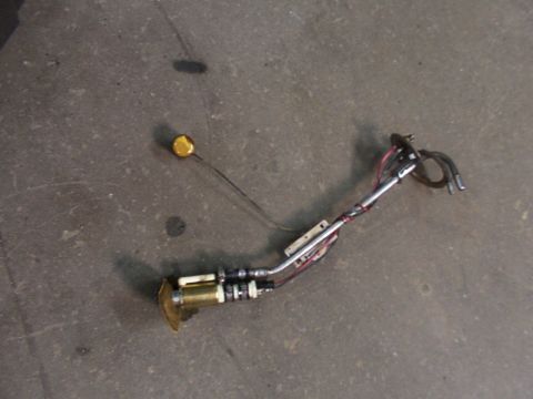 1988 Ford C-350 (Centurion Conversions) - Fuel pump assembly, likely for a vehicle, lying on a concrete surface.