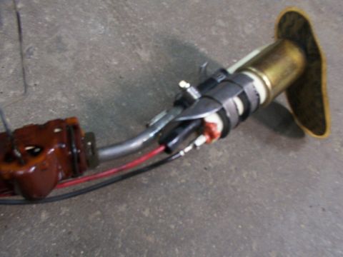 1988 Ford C-350 (Centurion Conversions) - A fuel pump assembly, likely for a vehicle, is shown against a concrete background.