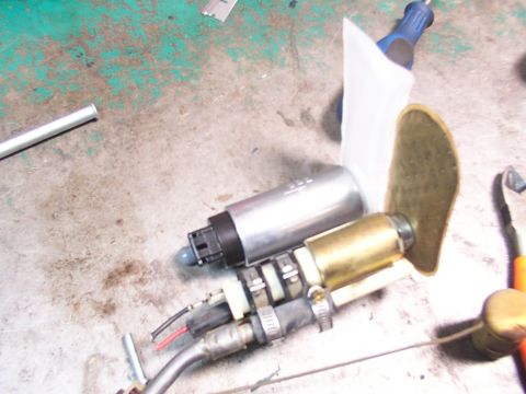 1988 Ford C-350 (Centurion Conversions) - Fuel pump assembly with filter sock and brass fitting on a workbench.